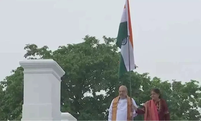 Union Home Minister Amit Shah hoists Tricolour at his residence as part of 'Har Ghar Tiranga' campaign